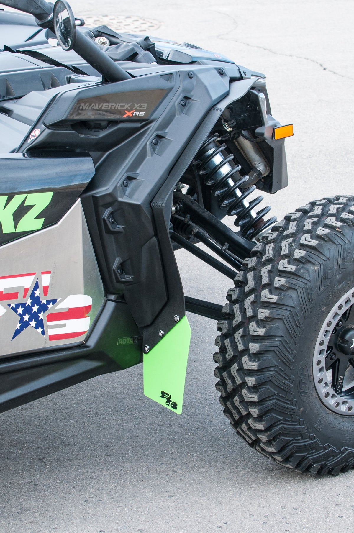 RokBlokz fender extensions installed on a 2017+ Can-Am Maverick X3 with BRP fenders, providing protection from mud and debris - front 2