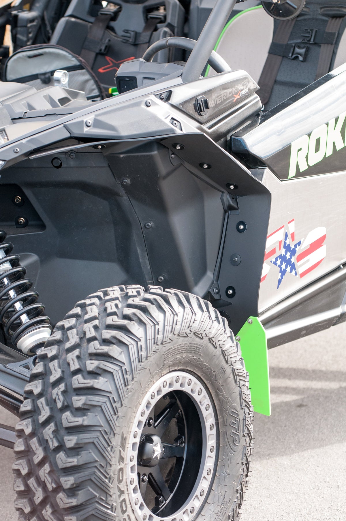 RokBlokz fender extensions installed on a 2017+ Can-Am Maverick X3 with BRP fenders, providing protection from mud and debris - front inside