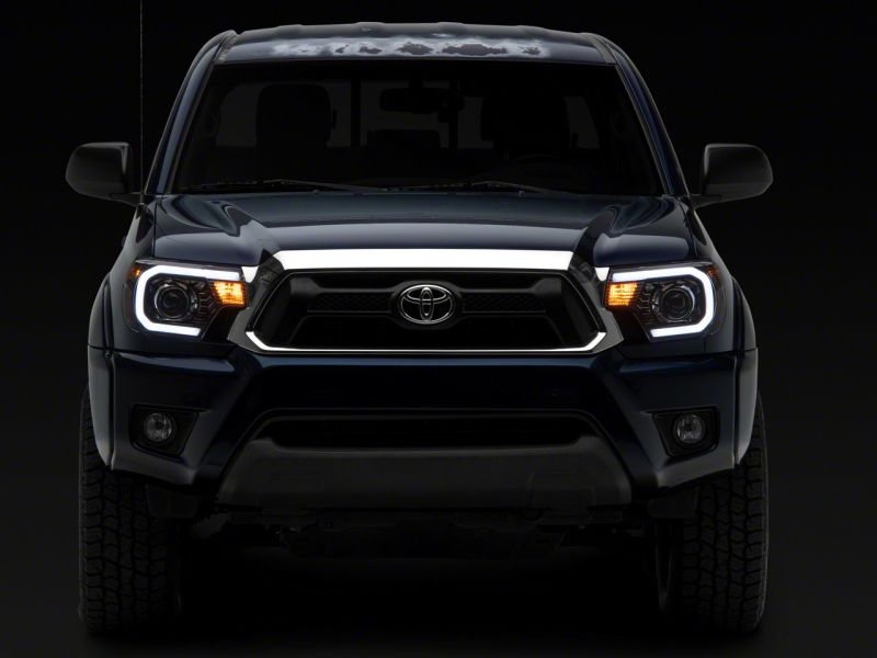 Raxiom 12-15 Toyota Tacoma Axial Projector Headlights w/ SEQL LED Bar- Blk Housing (Clear Lens) - TT21850