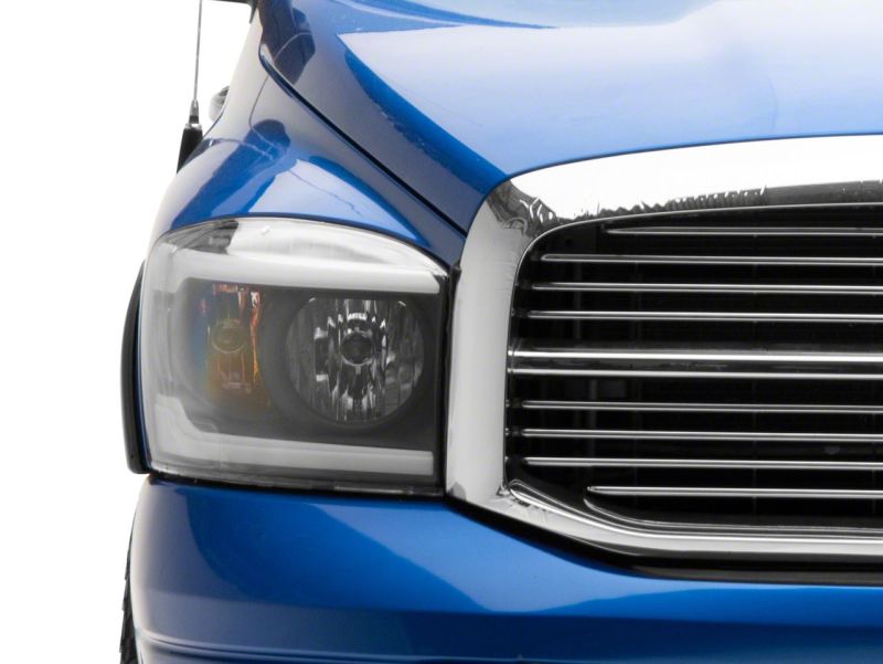 Raxiom 06-09 Dodge RAM 1500/2500/3500 Axial Headlights w/ SEQL LED Bar- Blk Housing (Clear Lens) - R131480