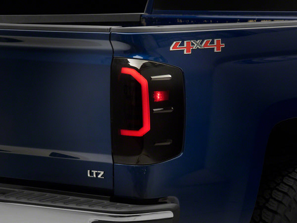 Raxiom 14-18 Chevrolet Silverado 1500 Axial Series LED Tail Lights- Blk Housing (Smoked Lens) - S151298 for 2014-2018 Chevrol