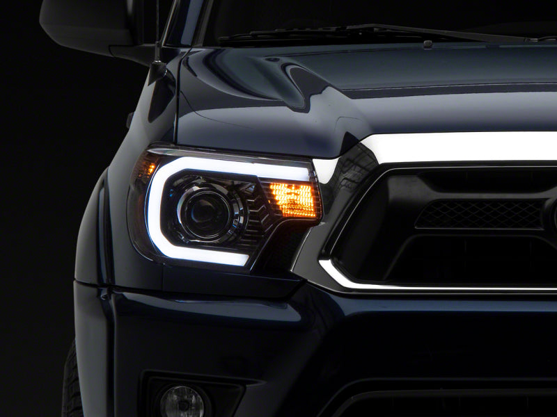 Raxiom 12-15 Toyota Tacoma Axial Projector Headlights w/ SEQL LED Bar- Blk Housing (Clear Lens) - TT21850
