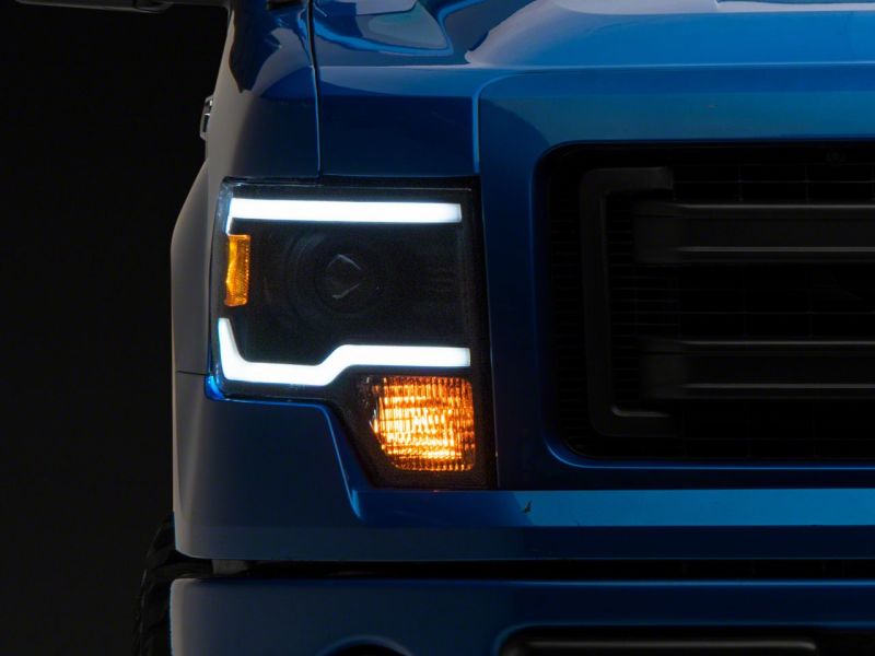 Raxiom 09-14 Ford F-150 Axial Series Projector Headlights w/ LED Light Bar- Blk Housing (Clear Lens) - T566369