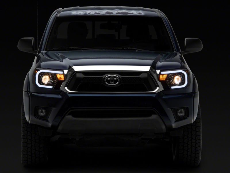 Raxiom 12-15 Toyota Tacoma Axial Projector Headlights w/ SEQL LED Bar- Blk Housing (Clear Lens) - TT21850