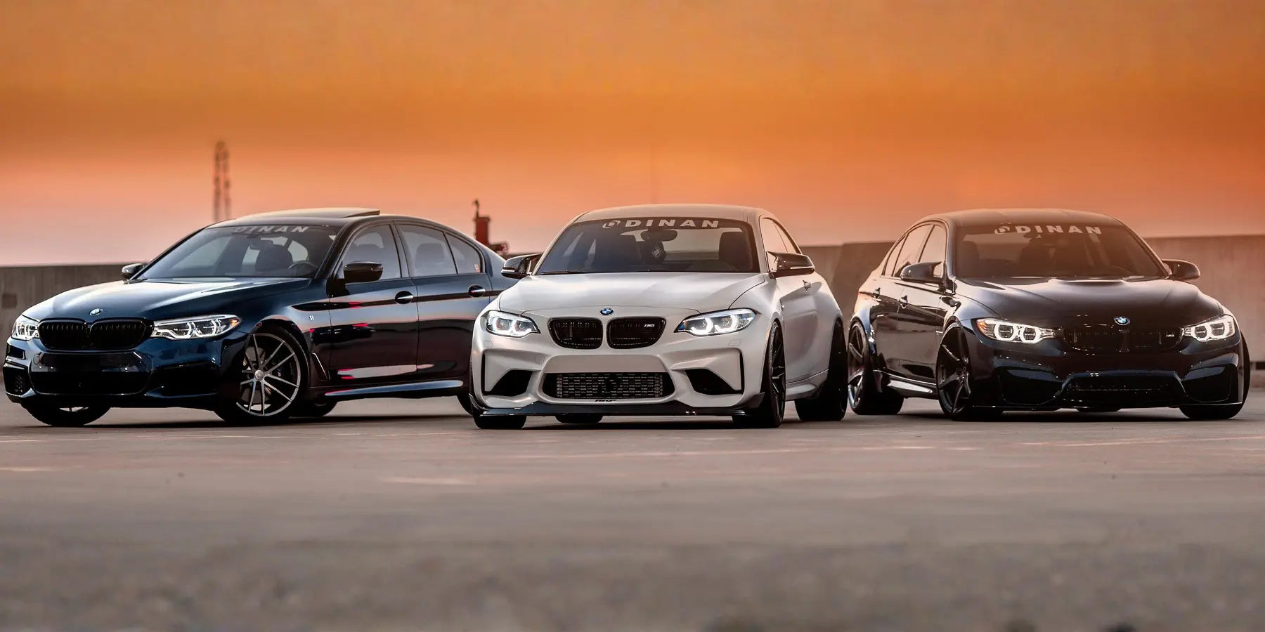 Three BMW M cars with Dinan Motorsport upgrades at sunset