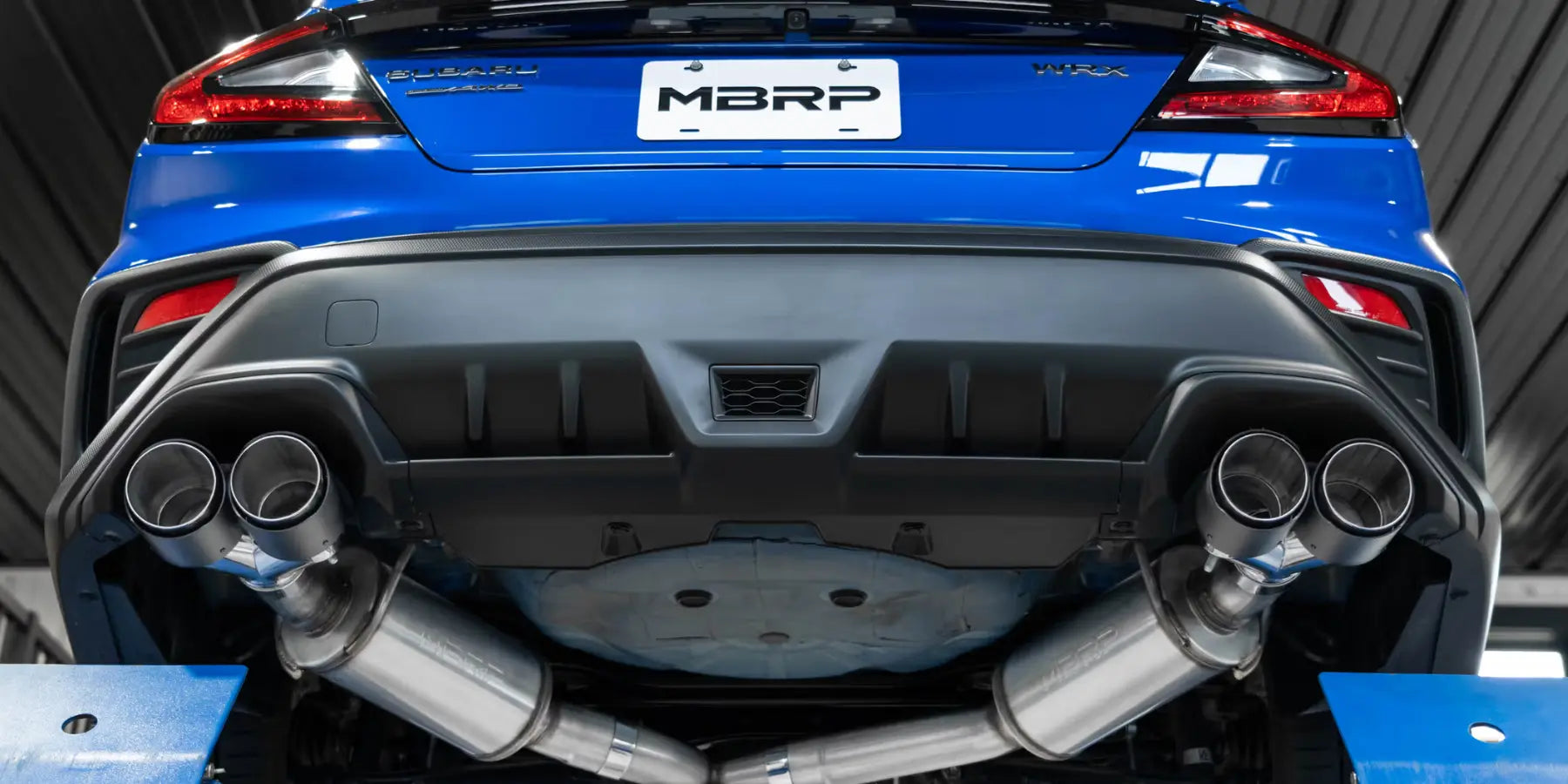 Blue Subaru WRX with an MBRP quad-tip cat-back exhaust