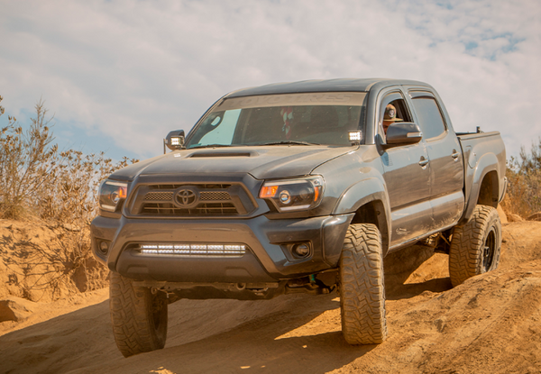 Cali Raised 05-15 Toyota Tacoma Low Profile Led Ditch Light Brackets Kit W/Amber Backlight - Tall - CR2864 - front view