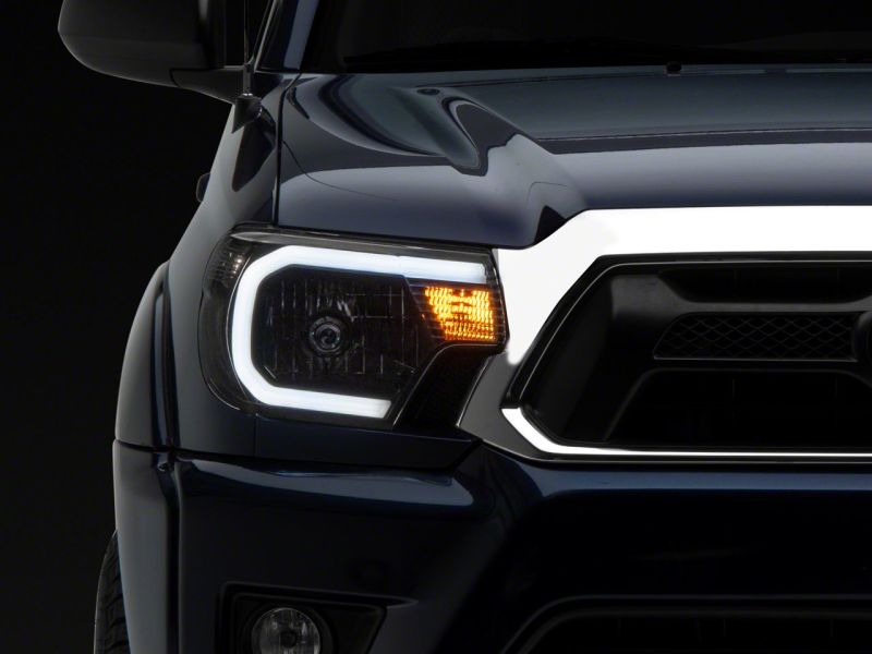 Raxiom 12-15 Toyota Tacoma Axial Series Headlights w/ LED Bar- Blk Housing (Clear Lens) - TT21847