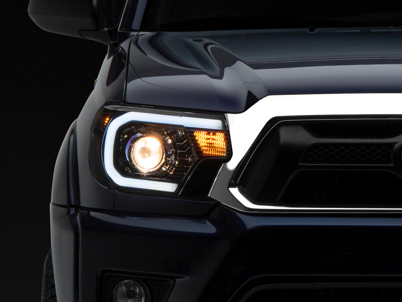 Raxiom 12-15 Toyota Tacoma Axial Series Projector Headlights w/ LED Bar- Blk Housing (Clear Lens) - TT21849