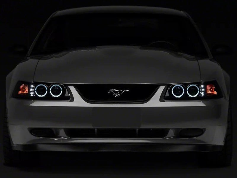 Raxiom 99-04 Ford Mustang Dual LED Halo Projector Headlights- Black Housing (Smoked Lens) - 49113